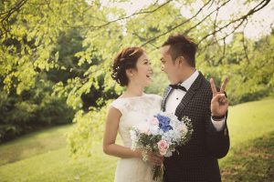 happy laughing prewedding couple green field