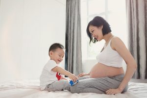 pregnant mama playing with toddler son