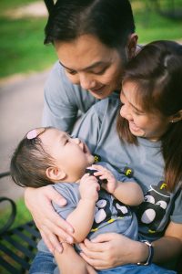 parents and one year old baby botanic garden smiling