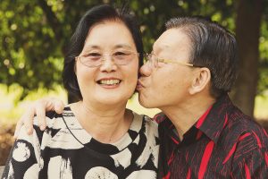 grandparents kissing outdoor photoshoot