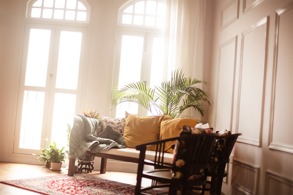 Oh Dear Studio interior decorated with colonial-style furnishing. Tall glass window with full natural light
