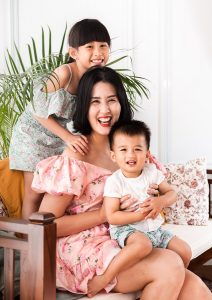 Mother with two children smiling happily in Oh Dear Studio