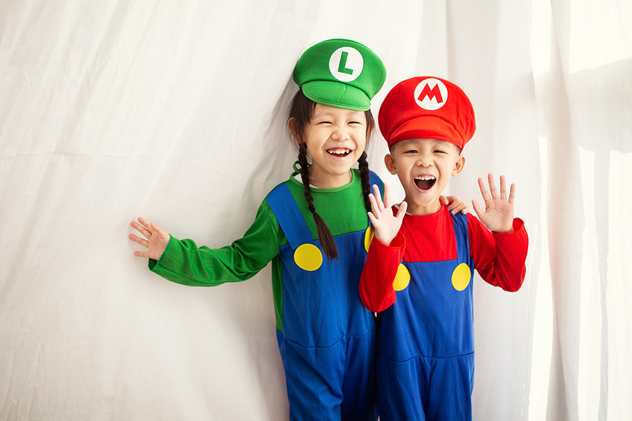 happy sibling wearing super Mario costume doing photoshoot in Oh Dear Studio