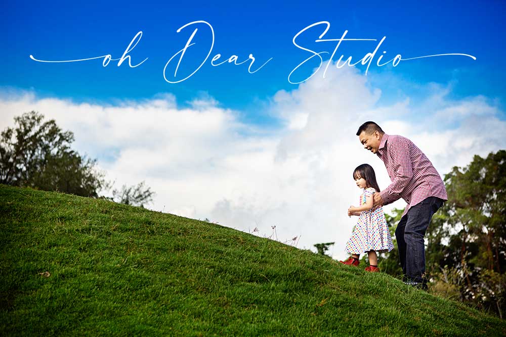 Father and daughter climbing up Jurong lakeside garden slope