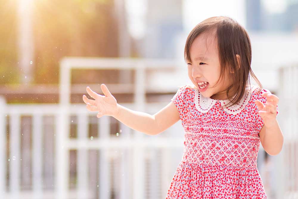 Little girl playing on rooftop