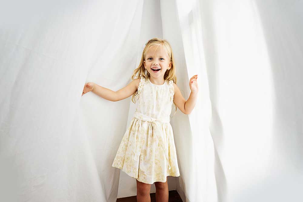 Russian little girl in white curtain