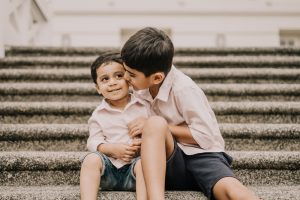 Brother kissing toddler brother at fort canning park Singapore