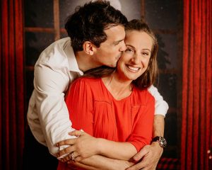 red curtain night couple photoshoot smiling