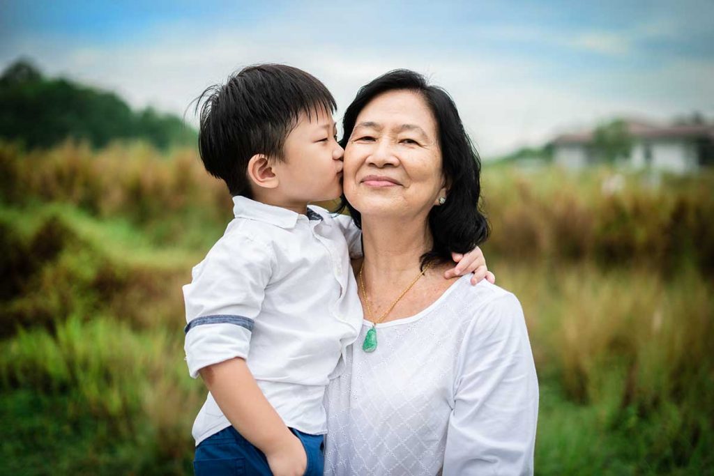 grandson kissing grandmother photoshoot