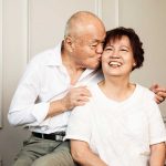 grandfather kissing laughing grandmother