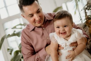 laughing baby and dad studio photo