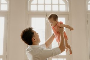 flying baby and father studio photo