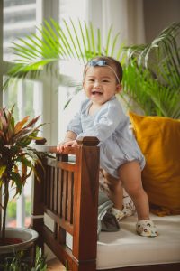 standing laughing 8 months old baby photography