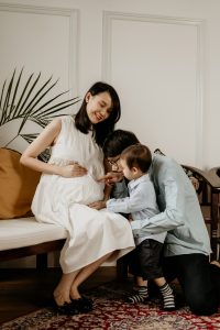 lifestyle toddler kissing mama maternity photoshoot