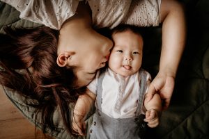 mother kissing 8 months old baby photo