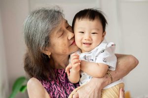 grandmother kissing laughing old year old baby boy