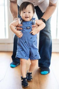 one year old special need baby boy walking