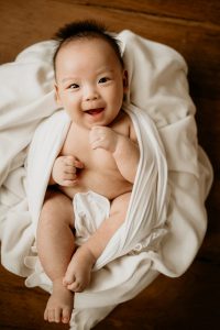 laughing 100 days old baby photoshoot