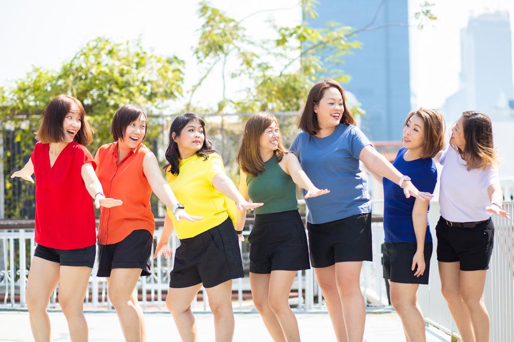 A group of friends posing happily for an outdoor shoot