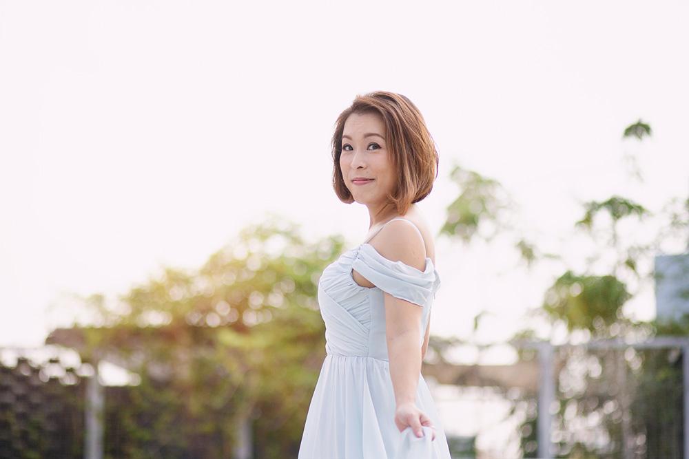 An outdoor shot of a lady in a white dress