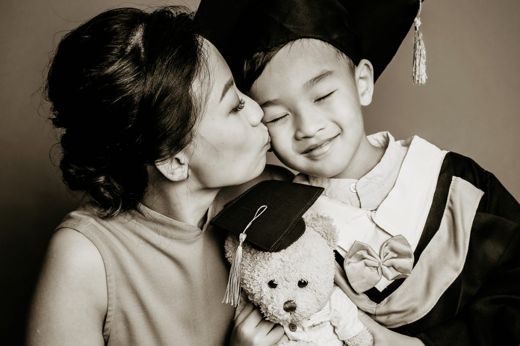 mother kissing k2 graduation son