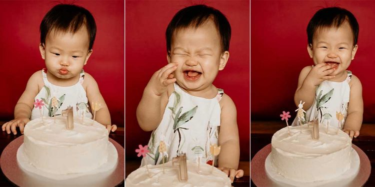 happy-one-year-old-birthday A baby girl smiling happily at the birthday cake infront of her