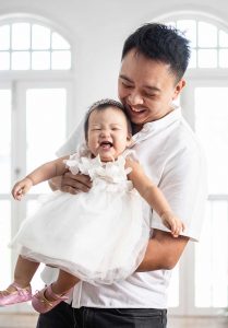 laughing baby girl 1 year old with father in Oh Dear Studio