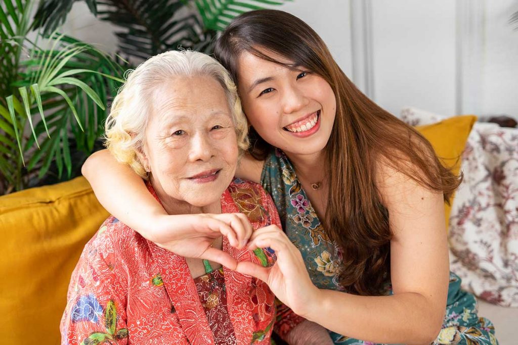 elderly grandmother and granddaughter laughing