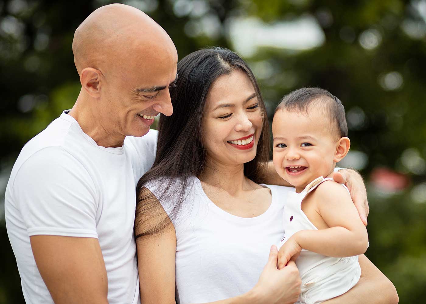 one year old baby boy with family smiling