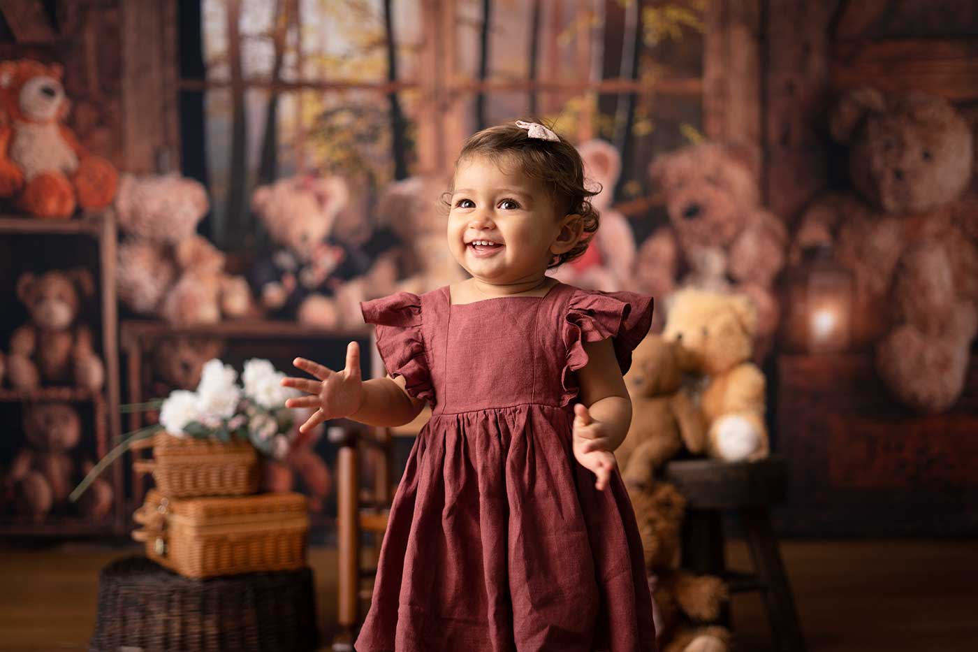 one year old french baby girl smiling bear photo studio