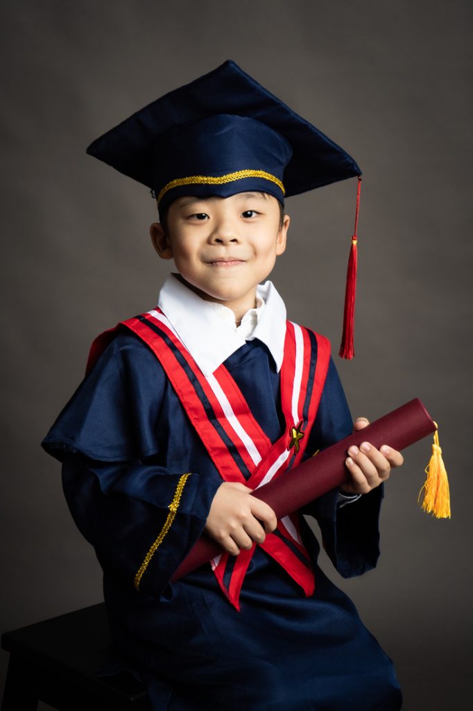 k2 graduation little boy smiling at camera