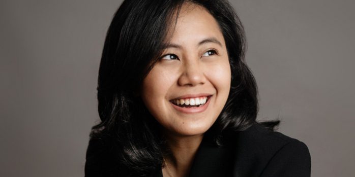 lady CEO friendly formal corporate studio business lady in business suit smiling brightly for a photoshoot