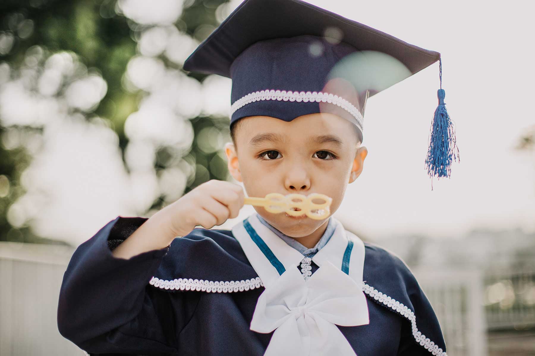 6 year old k2 graduation blow bubbles outdoor