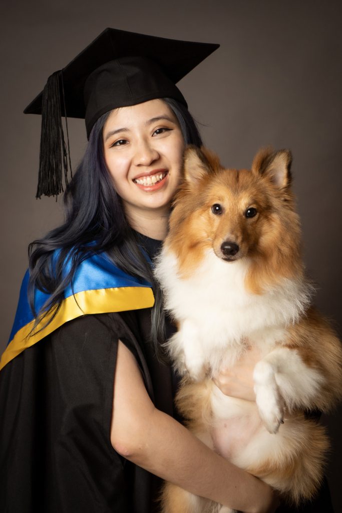 smiling classic graduation photoshoot with pet dog