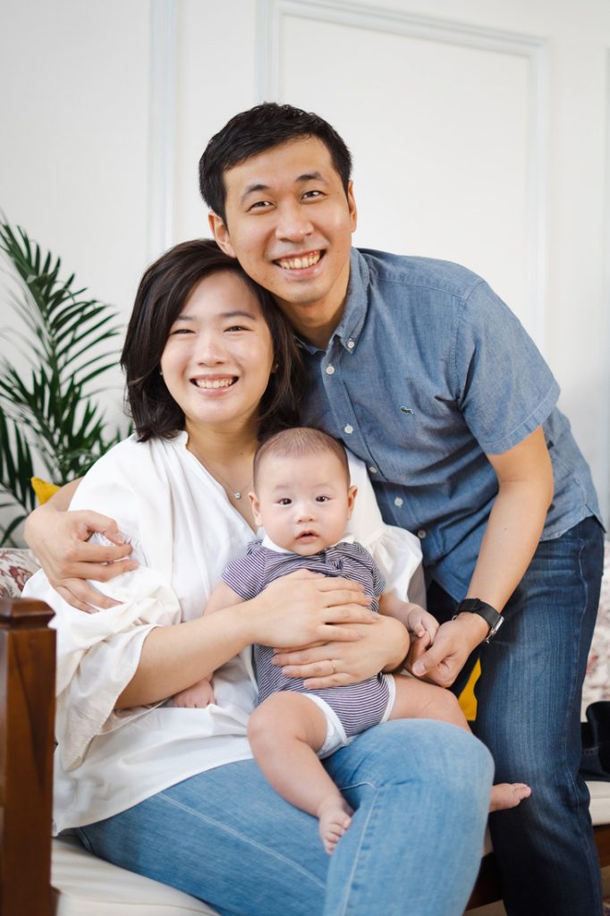 smiling parents with 100 day old baby photoshoot in Oh Dear Studio