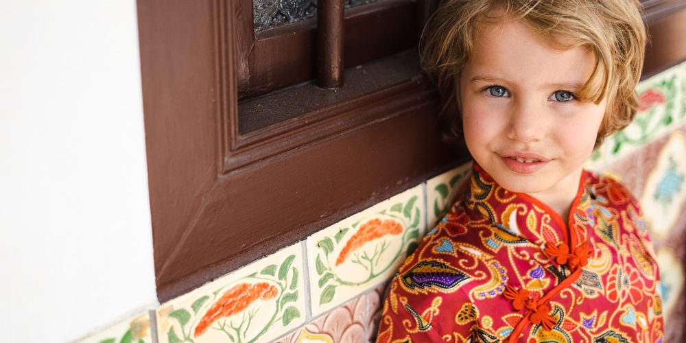 SIA-SQ-dress-expat-shophouse-peranakan Close-up shot of an expat child dressed in red cheongsam
