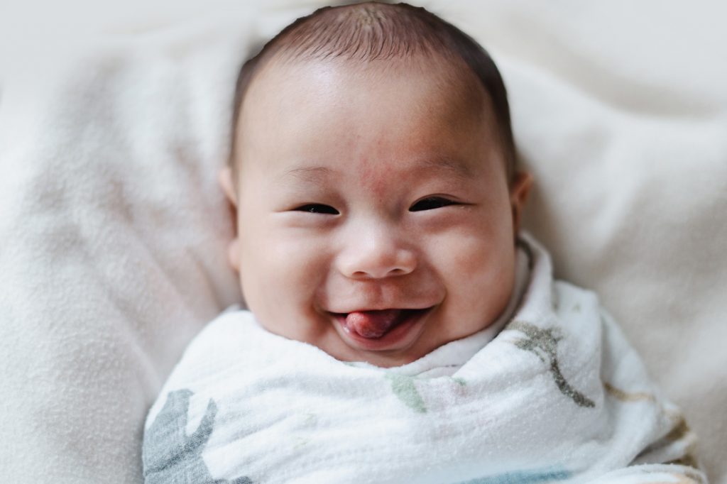 grinning 100 day old baby