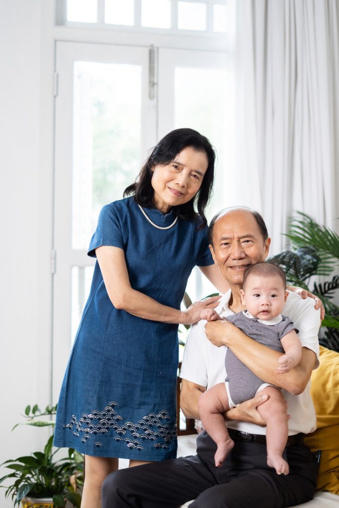 grandparents smiling with 100 day old baby photoshoot in Oh Dear Studio