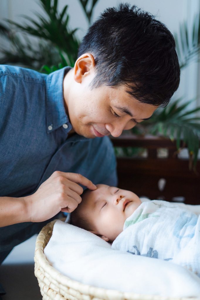 father and 100 day old baby sleeping