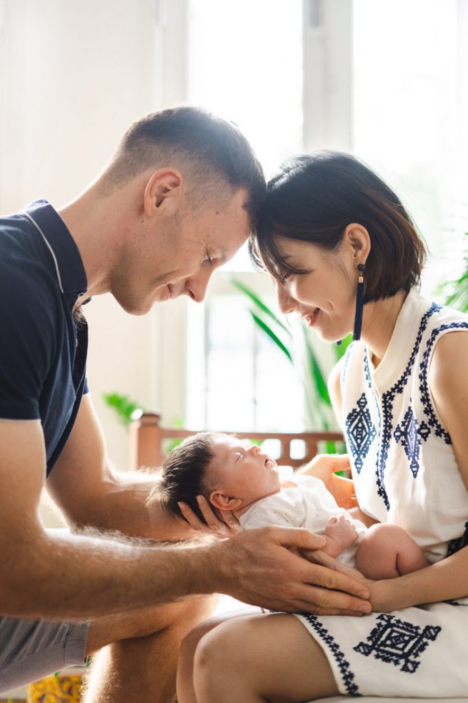 proud parents looking at newborn 