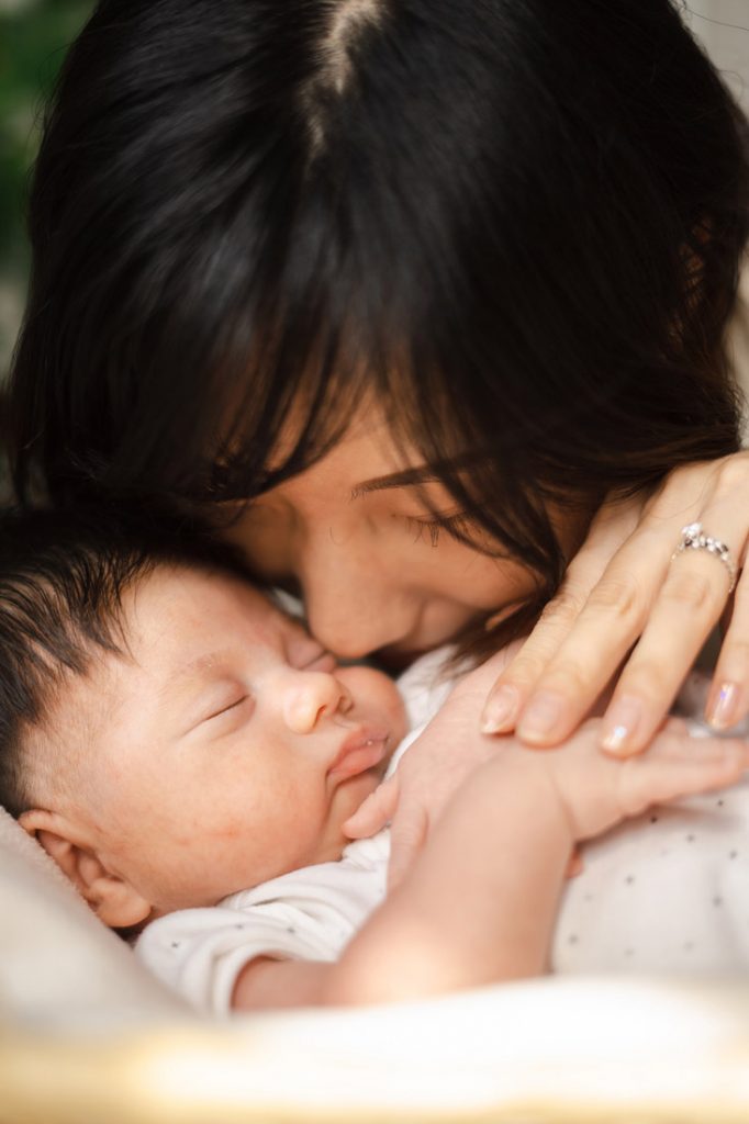 mother and newborn infant closeup photo