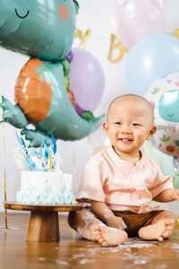 baby boy one year old smiling cake smash