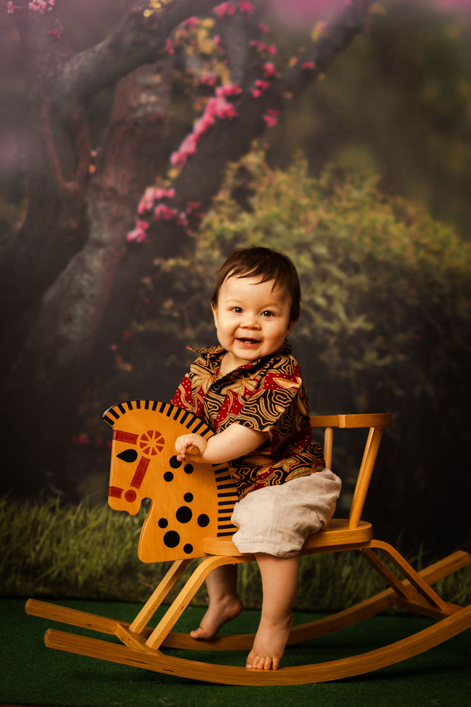 baby boy rocking horse peranakan batik smiling