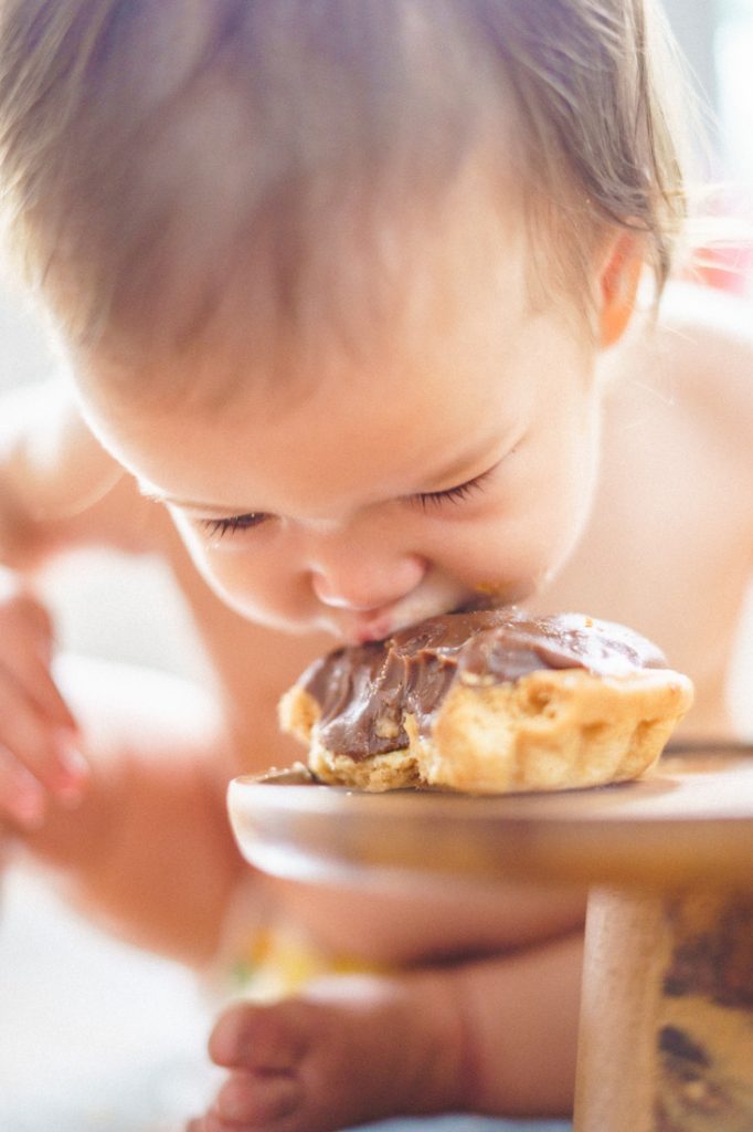 close up baby eating tart smash cake