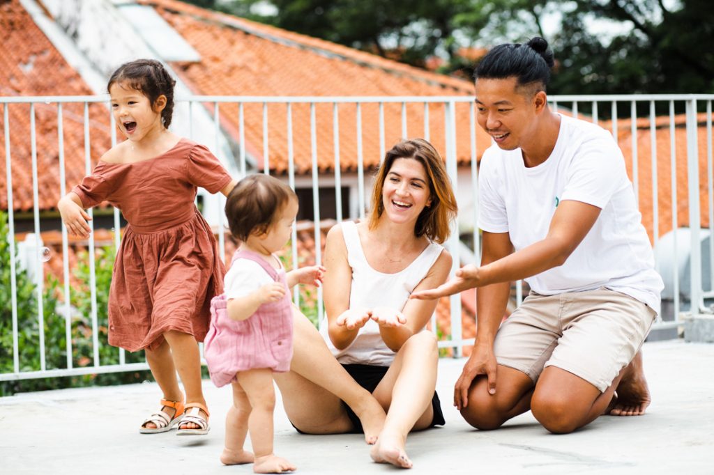 candid picture of family playing at studio rooftop