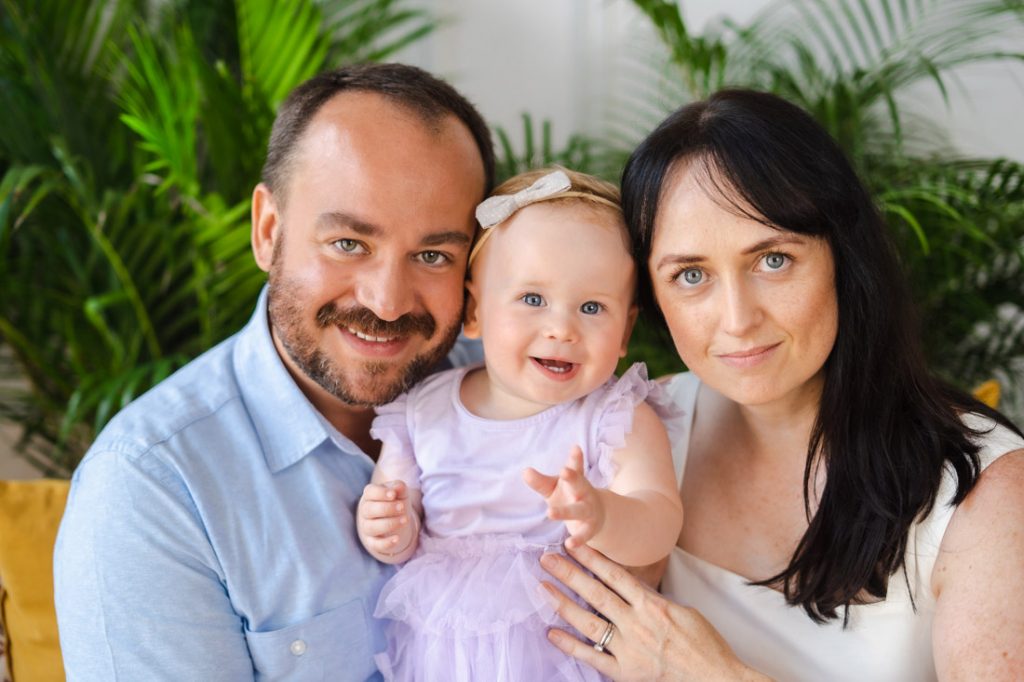 parents and one year old baby toddler smiling