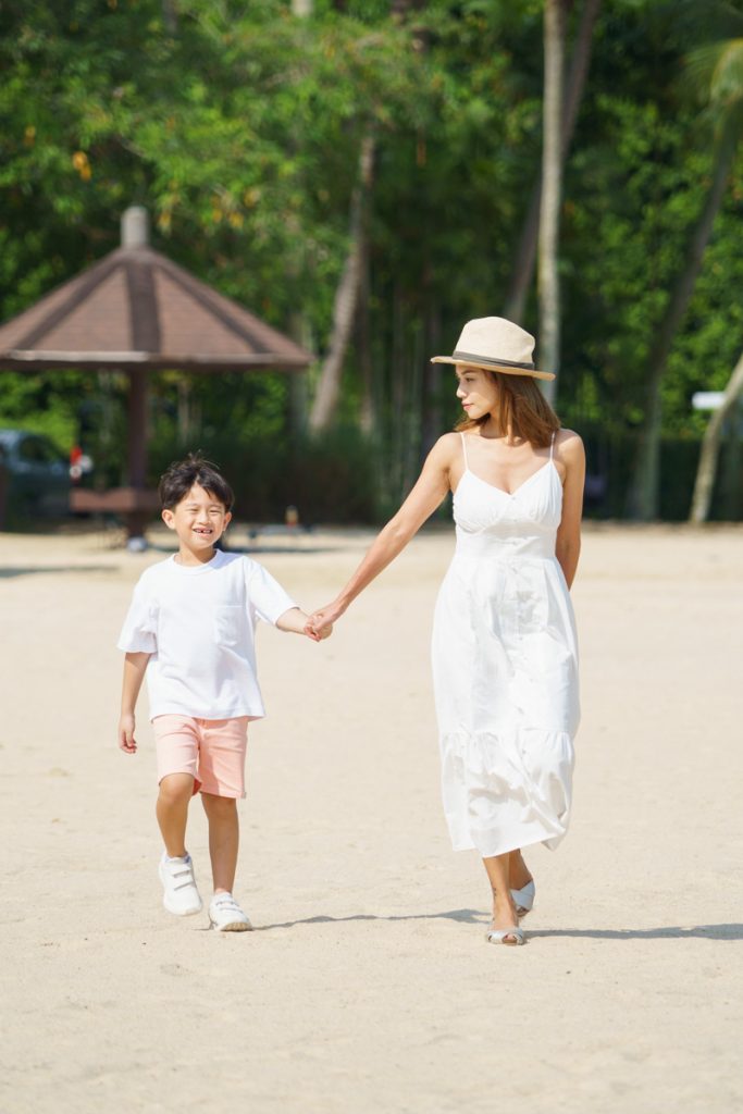 mother and son walking on sentosa tanjong beach