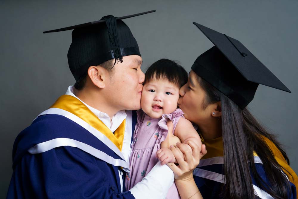 graduate parents NTU kissing baby
