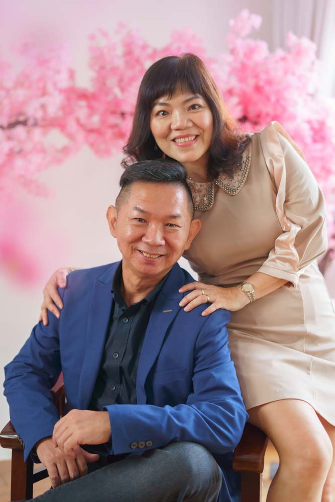 Parents couple portrait in studio pink sakura tree