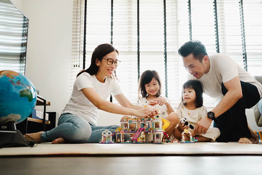 family playing lego at home during professional photoshoot